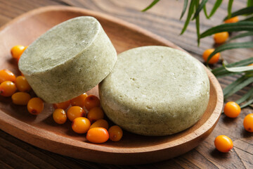 Solid shampoo pieces with sea buckthorn berries extract or homemade natural organic soap bars on...