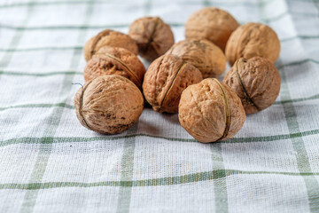 Walnuts isolated on a beautiful white towel. Background for the menu. Space for text