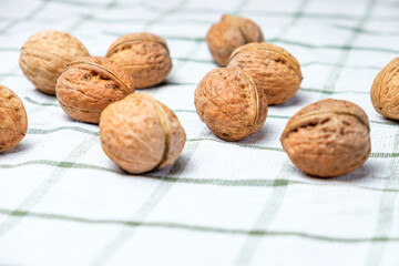 Walnuts isolated on a beautiful white towel. Background for the menu. Space for text