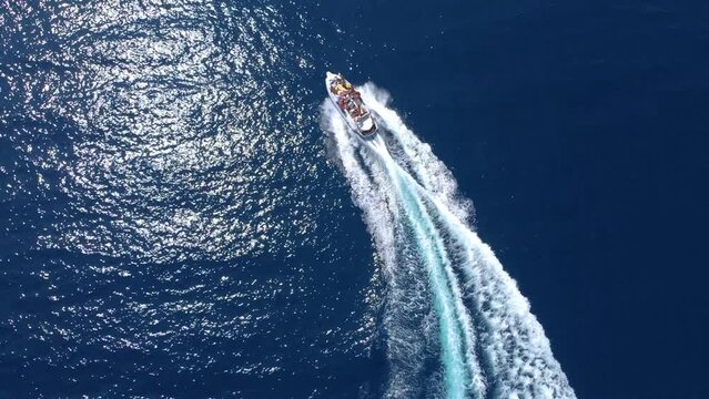 Aerial view of a motor boat sailing around the Porto Palermo Fort in Vlora, Albania