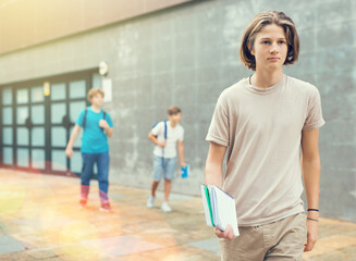 Fototapeta premium Portrait of teenager boy going to school lessons on sunny summer day