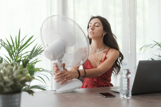 Woman cooling herself at home