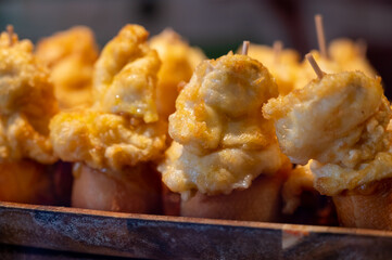 Typical snack is bars of Basque Country, pinchos or pinxtos, small slices of bread upon which ingredient or mixture of ingredients is placed and fastened with toothpick, San Sebastian, Spain