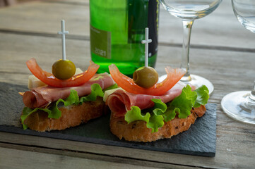 Typical snacks of Basque Country and Navarre, pinchos or pinxtos on skewers served outdoor, Bakio, Spain
