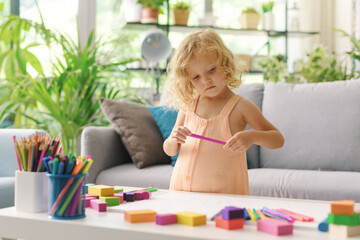 Cute girl coloring with markers