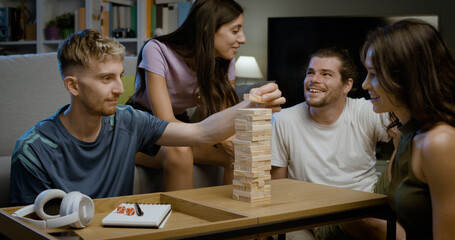 Group of friends playing Jenga together