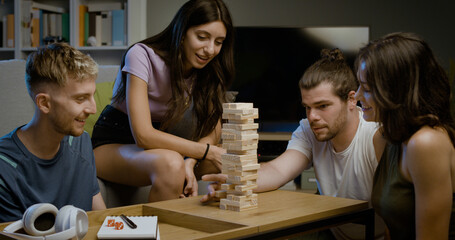 Group of friends playing table games at home