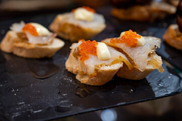 Typical snack of Basque Country and Navarre, pinchos or pinxtos served in bar, small slices of bread upon which ingredient or mixture of ingredients is placed, San Sebastian, Spain