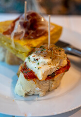 Typical snack of Basque Country and Navarre, pinchos or pinxtos, small piece of bread with different toppings, served in bar, Bilbao, Spain