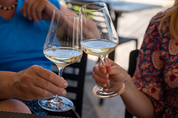 Drinking of txakoli or chacolí slightly sparkling very dry white wine produced in Spanish Basque Country, served in restaurant in Getaria, Spain