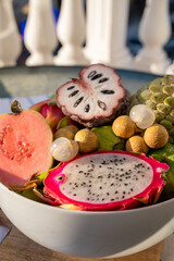 Variaty of tropical exotic fruits, ripe fresh lychee, dragon fruit, guava and cherimoya
