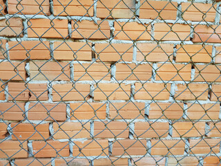 Naklejka premium close up brick and cement concrete texture with steel wire mesh, close up of wall background