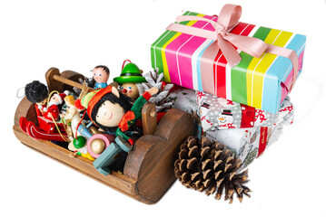 Wooden box with Christmas decorations and Christmas gifts on a white background.