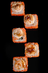 Sushi rolls with caviar on black plate. Serving Japanese food