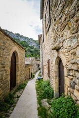 Fototapeta na wymiar View on the beautiful stone facades and medieval houses of the small historical village of Rochecolombe in the South of France (Ardeche)