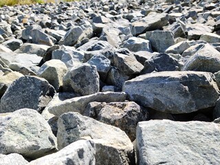 Fototapeta na wymiar Granite Waste rock large piles under the sun