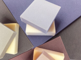 colorful square sponge foam pieces neatly arranged in a square shape. a collection of pastel colored soft materials with different thickness - obrazy, fototapety, plakaty