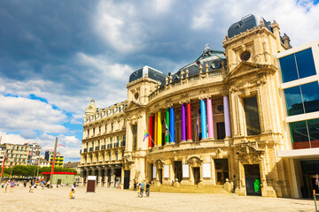 View of medieval baroque building of Flemish Opera in Antwerp with facade columns painted in rainbow colors during traditional annual Gay Pride, Belgium
