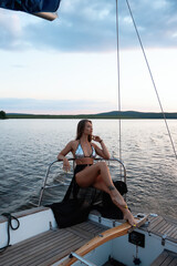 Feminine woman enjoying summer day on yacht with closed eyes
