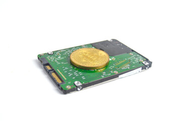Computer hard drive and bitcoin on white background, copy space