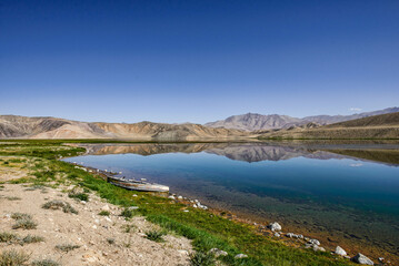 Fototapeta na wymiar Reflecting rainbow mountains on Lake Bulunkul, Pamir Highway, Tajikistan
