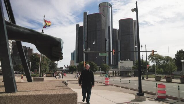 Man walking towards camera by the Joe Louis fist statue in Detroit, Michigan with gimbal video walking forward.