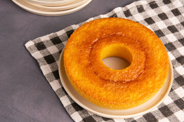 Brazilian Corn Cake (Bolo de Fuba) on a checkered towel, isolated, close up, vertical