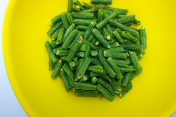 chopped long beans and put in a yellow bowl.Fresh yard long bean have sweet taste and crisp, high nutrition and vitamins. Food and vegetable concept.