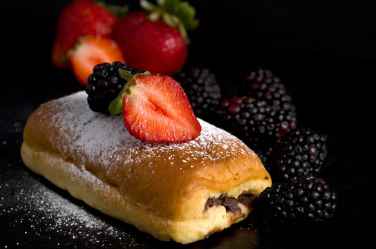 Macro Image of Chocolate Pastry with Strawberries, Blackberries and Powdered Sugar