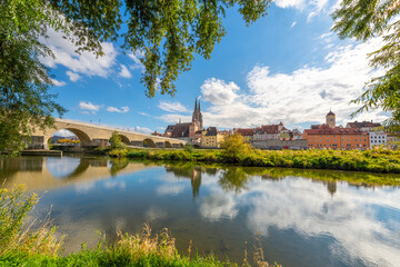 Naklejka na ściany i meble The picturesque skyline including the stone bridge over the Danube River, Saint Peter's Church and Regensburg Town Hall in the Bavarian city of Regensburg, Germany.