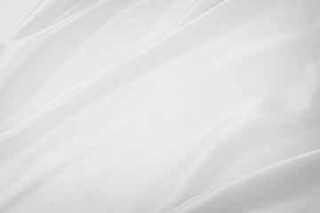 Fototapeta na wymiar ドレープのあるシルクの白い布の背景テクスチャー