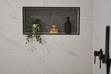 Tiled wall niche in modern bathroom.