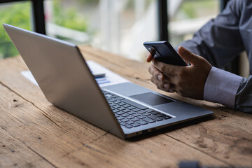 Business men and women holding smartphones at work. Project statistics. Financial data sales chart on the table. close-up view