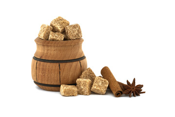 Sugar cubes in bowl next to cinnamon sticks and anise