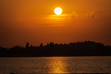 The sun goes down over a lake