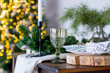 A wine glass on the festive Christmas table.