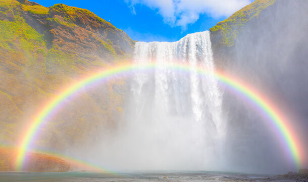View of famous Skogafoss waterfall with amazing double rainbow - Icelandic Landscape concept 