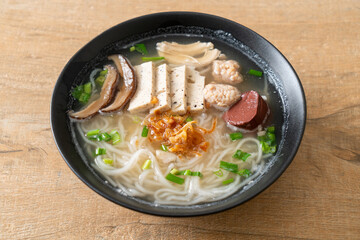 Vietnamese Rice Noodles Soup with Vietnamese Sausage served vegetables and crispy onion