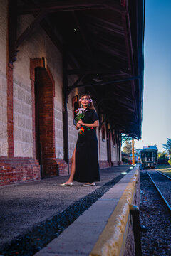High quality photography. Woman with the makeup of the catrina. Makeup for the celebration of Day of the Dead in Mexico. Outdoors portrait. Woman in a train station.