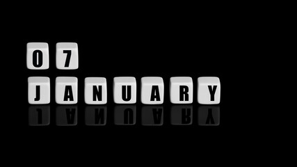 January 7th. Day 7 of month, Calendar date. White cubes with text on black background with reflection.Winter month, day of year concept