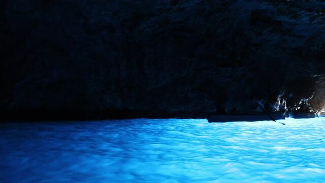 Tourist inside the Blue Cave (Grotta Azzurra) in the island of Capri