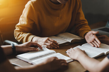 Christian couple or group reading study the bible together and pray at a home or Sunday school at church. concept studying the word of god. - obrazy, fototapety, plakaty