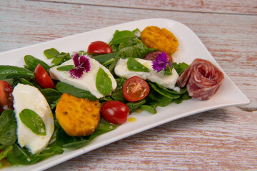 Arugula and spinach salad recipe with mozarella sausage, prickly pear vinaigrette. High quality photo