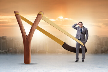Businessman being launched from slingshot in career concept