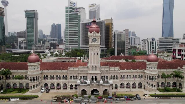 Sultan Abdul Samad Building in Kuala Lumpur, Malaysia. Drone pullback shot with Merdeka Square and city skyline in distance. 