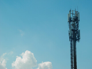 Telecommunication tower with cellular antennas for 5g mobile internet network on blue sky background