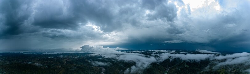 Aerial panorama of foggy hills after a heavy thunderstorm. Panorama captured with a drone in Resita city area, Romania.