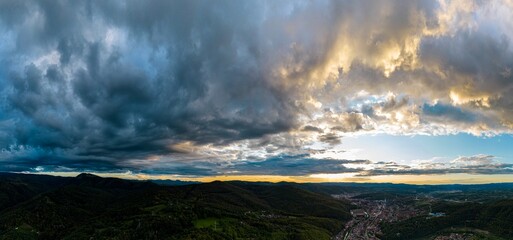 Aerial panorama view of colorful sunset over Resita city, Romania. Captured from a drone.