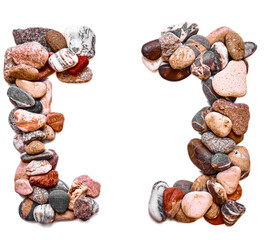 A letter of smooth stones on a white isolated background. Of the river stones lined with a letter, detailing, close-up. Selective focus