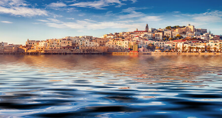 Vieste town reflected in the calm waters of Adriatic sea, Gargano National Park. Picturesque summer scene of Apulia, Italy, Europe. Traveling concept background.